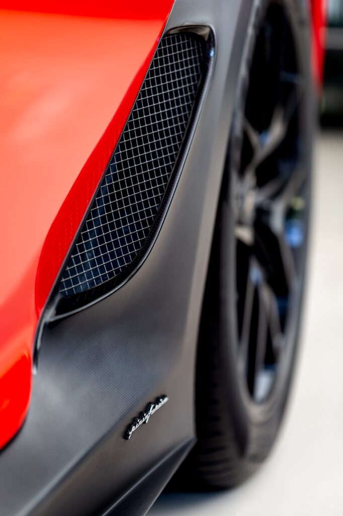 Luxury red car closeup details. Fancy Ferrari front.